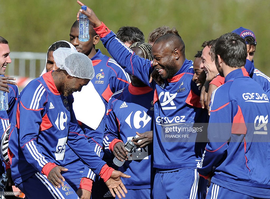 French football team players William Gallas (C), Sidney Govou (4thR), Sebastien Squillaci (3rdR) and Djibril Cisse (L) laugh after a buggy race on May 23, 2010 in Tignes, French Alps, where the French football team is practicing as part of the preparation for the upcoming World Cup 2010. French defender William Gallas has a mild accident during this race. AFP PHOTO / FRANCK FIFE (Photo credit should read FRANCK FIFE/AFP via Getty Images)